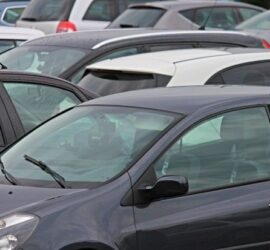 Cars parked closely in a crowded lot.
