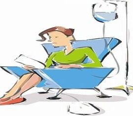 Woman sitting, receiving intravenous therapy, reading paper.