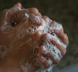 Hands washing with soap and bubbles.