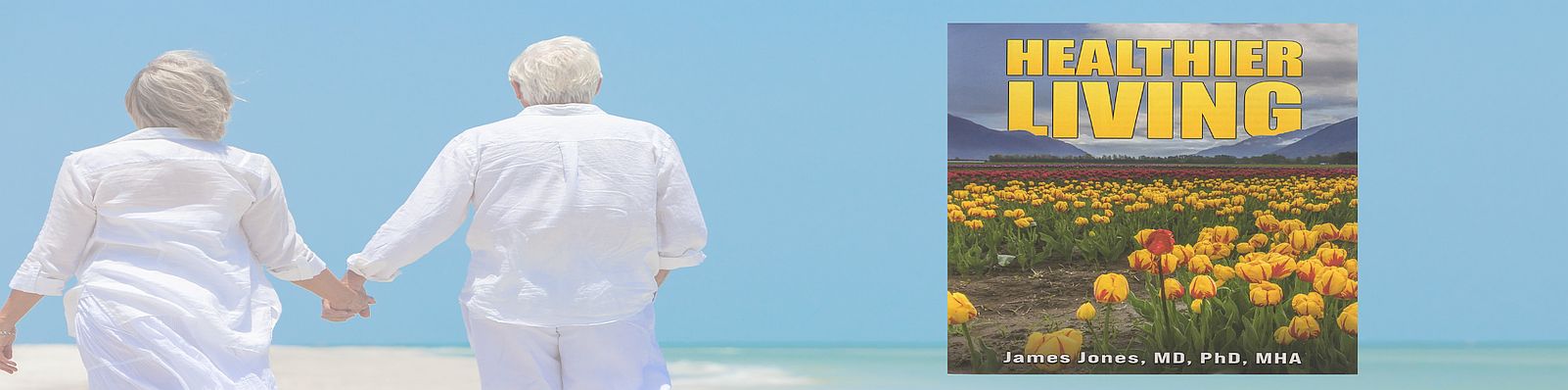 A person in white stands on a beach with a clear blue sky and ocean.