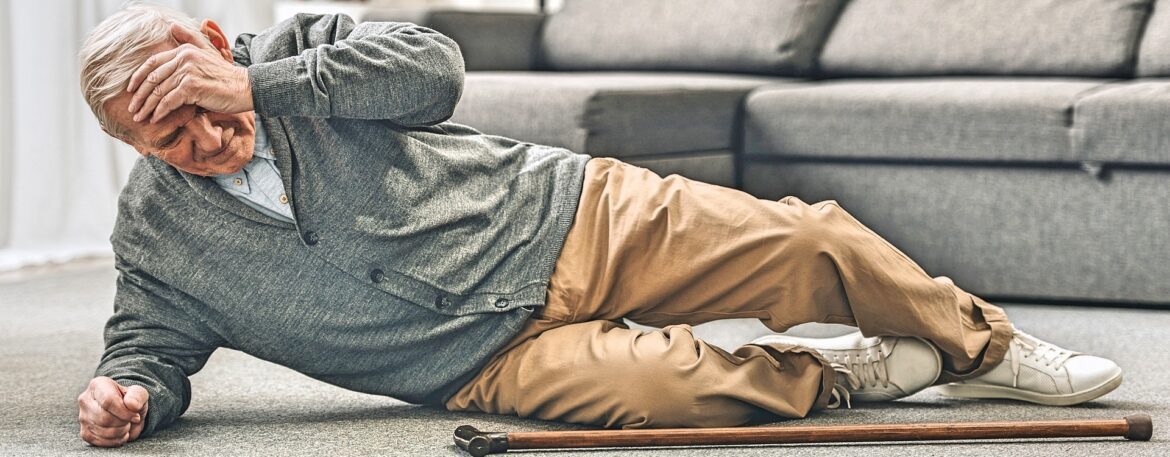 Elderly man fallen on the floor indoors.