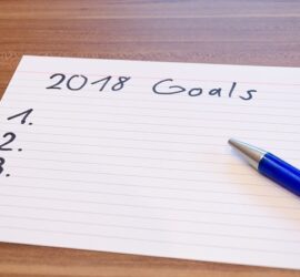 A blank 2018 goals list with a blue pen.