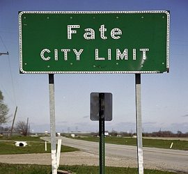 Green "Fate City Limit" roadside sign.