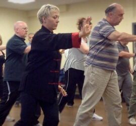 A group practicing tai chi in a community setting.