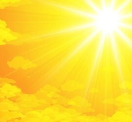 Bright sun shining over yellow clouds.