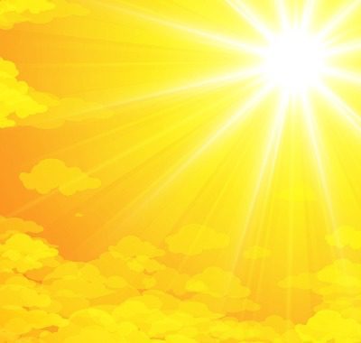 Bright sun shining over yellow clouds.