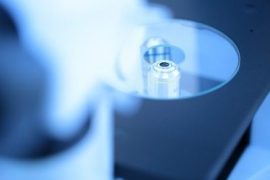 Microscope lens focused on laboratory sample.