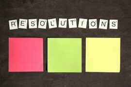 Resolutions with colorful sticky notes underneath.